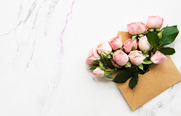 Envelope and pink roses