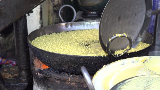 Street trade food : cooking chiape rayta on the street market in city Udaipur, Rajasthan, India. Indian chef making street food. Close up