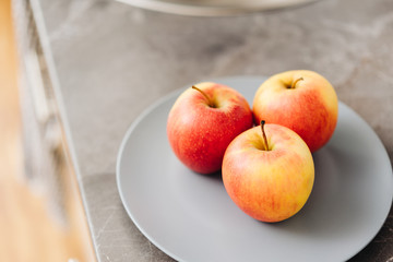 Three healthy fresh red apples on a plate