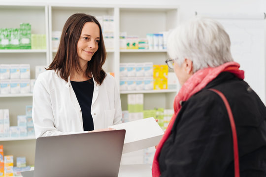 Sympathetic female pharmacist listening to a woman