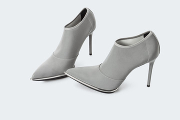 Grey transparent fabric high heel shoes over white background