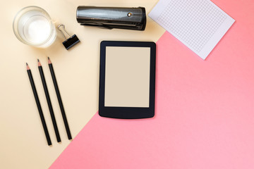 Close up of creative office desktop with empty tablet supplies and other items with copy space. Mock up, Above view
