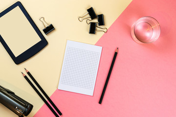 Close up of creative office desktop with empty tablet supplies and other items with copy space. Mock up, Above view