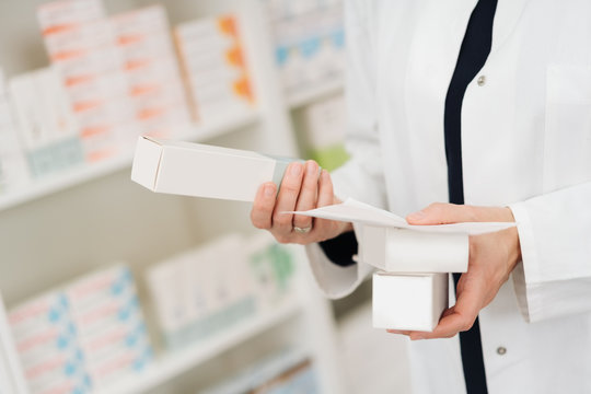 Pharmacist reading the information on medication