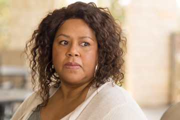 African American middle age woman looking sad.