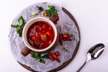 Goulash soup bograch in a bowl. Hungarian dish. Top view on white background.