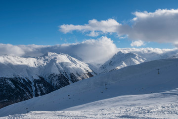 Fototapeta na wymiar Alpine Ski Resort And Ski Slopes in Winter, Livigno, Italy