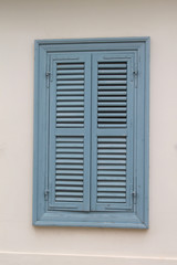 Wooden window with closed shutters