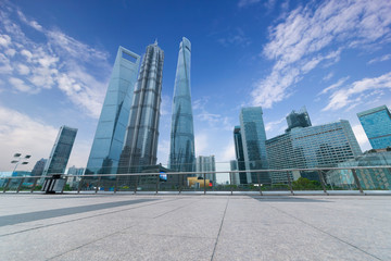 The pedestrian pavement under the tall building large building.