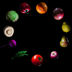 fruits and vegetables on a dark background in space isolates