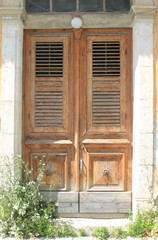 Fototapeta na wymiar Vintage wooden front door in sunlight