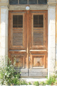 Vintage wooden front door in sunlight