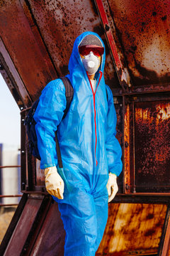 man environmental mask face pack disguise facemask bitmask protective overall blue orange rast plant factory disused catastrophe