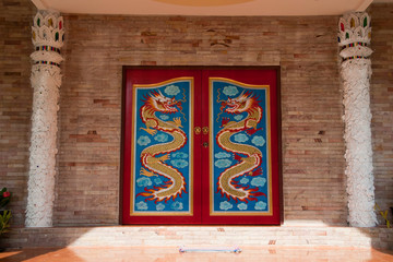 Tha Ton Thailand, painted serpents on doors of building at Wat ThaTon 