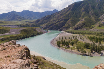 Fototapeta na wymiar Panoramic view of an Altai mountain Katun river. Place of confluence of Katun and Chuya rivers. Summer time.