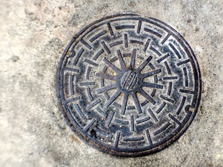 Drain cap isolated on cement background