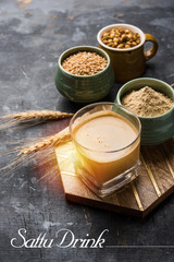 Sattu sharbat is a cooling sweet drink made in summer with roasted black chickpea flour, barley, suger, salt & water. served in a glass. selective focus