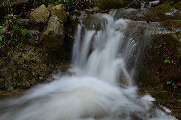 Fototapeta premium beautiful waterfall with clear water on a mountain stream in the forest