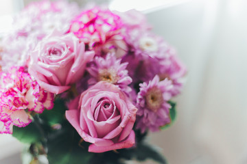 Fototapeta premium Close-up pink lilac bouquet, flowers - roses, gerberas on a white blurred background