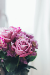 Close-up pink lilac bouquet, flowers - roses, gerberas on a white blurred background