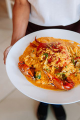 Thai Crab yellow curry creamy sauce in white plate