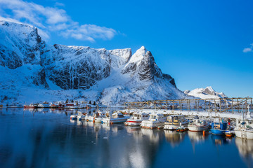 Wooden bridge on the water leading to the village on Lofoten Islands in Norway.