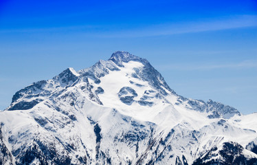 Fototapeta na wymiar peak covered of snow in winter with a blue sky