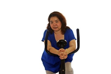 Fototapeta na wymiar Fat women wear a blue shirt are exercising by cycling, isolated on white background.