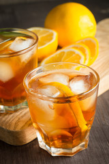 Glasses of cold ice tea with lemon, ice, mint on background. Homemade lemonade. Spring and summer drinks and beverages concept. 