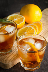 Glasses of cold ice tea with lemon, ice, mint on background. Homemade lemonade. Spring and summer drinks and beverages concept. 