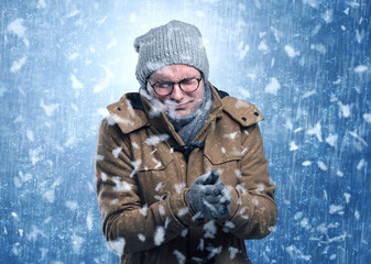 Handsome young boy shivering and trembling at snowstorm concept
