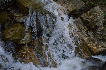 beautiful waterfall with clear water on a mountain stream in the forest