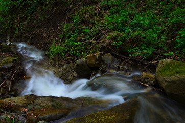 beautiful waterfall with clear water on a mountain stream in the forest