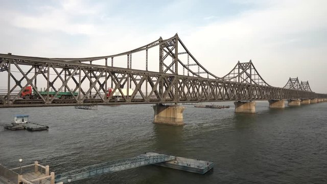 two Truck crossing korean chinese friendship bridge from Sinuiju DPRK to Dandong China which is under United Nations embargo