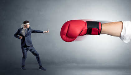 Little man fighting with a giant red boxing glove
