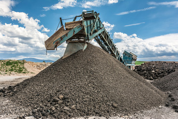 Recycling plant. Transforming asphalt from a gravel road to the construction of a new highway