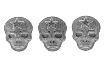 Grey MDMA, Amphetamine, Army Skull, Ecstasy, XTC pills isolated on a white background.