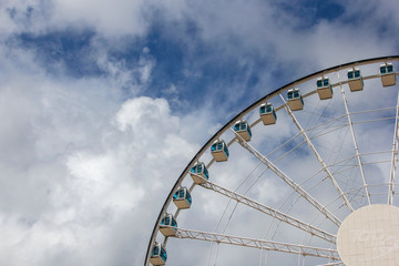 City under the blue sky white cloud ferris wheel