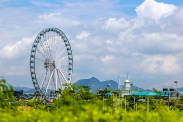 City under the blue sky white cloud ferris wheel - Powered by Adobe