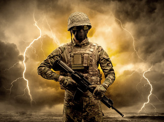 Armed soldier standing in rainy obscure weather
