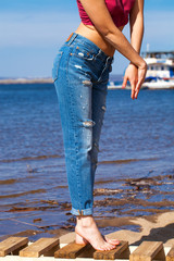 Front view of a long women legs posing with jeans