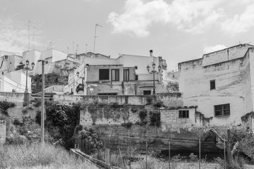 Fototapeta na wymiar Massafra and its ravines. Houses built in the rock. Puglia in Black and White. Italy