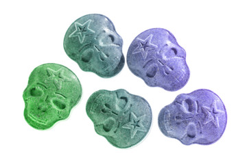 Party drugs: many coloured Amphetamine, Army Skull, Ecstasy, XTC pills isolated on a white background.