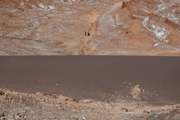 Fototapeta na wymiar Sand dunes and rocks in the extreme landscape of the Atacama desert