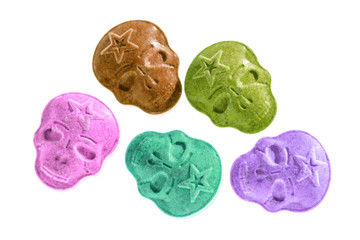 Party drugs: many coloured Amphetamine, Army Skull, Ecstasy, XTC pills isolated on a white background.