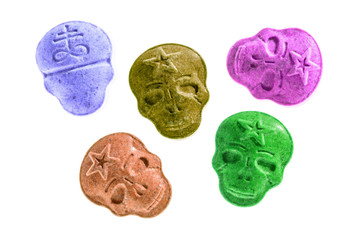 Party drugs: many coloured Amphetamine, Army Skull, Ecstasy, XTC pills isolated on a white...