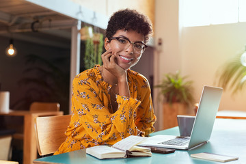 Smiling girl using laptop