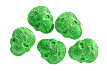 Green MDMA, Amphetamine, Army Skull, Ecstasy, XTC pills isolated on a white background.