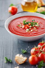 Tasty summer tomato soup served in bowl