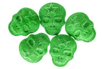Green MDMA, Amphetamine, Army Skull, Ecstasy, XTC pills isolated on a white background.